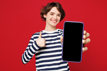 Young smiling satisfied happy woman she wear blue striped sweatshirt casual clothes hold in hand...
