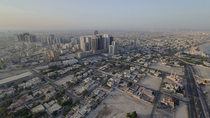 Fototapeta premium Cityscape of Ajman from rooftop during the morning after sunrise timelapse.