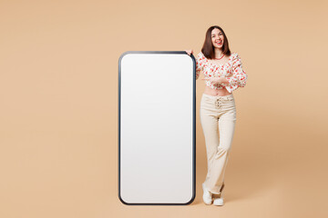 Full body young woman she wear white top casual clothes point index finger on big huge blank screen...