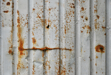 Rusty corrugated metal sheet showing signs of age and weathering