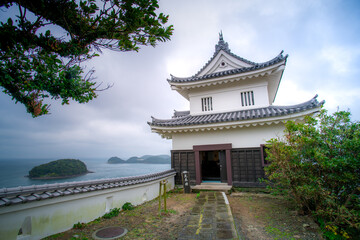 Fototapeta premium Hirado Castle, or Hirado-jo, also known as Kameoka Castle, was built on top of a small, rounded mountainous peninsula facing Hirado Bay, Hirado, Nagasaki, Japan