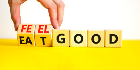 Eat and feel good symbol. Concept words Eat good Feel good on wooden cubes. Beautiful yellow table white background. Doctor hand. Healthy lifestyle eat and feel good concept. Copy space.