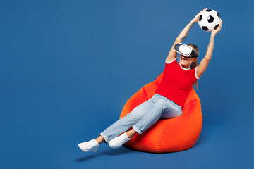 Full body young woman fan she wear red t-shirt support football sport team hold catch soccer ball...