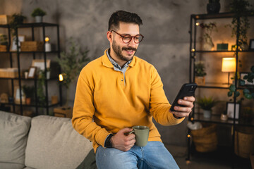 adult man wear eyeglasses and have fun while use cellphone at home