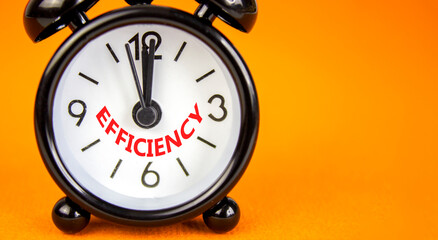 Efficiency symbol. Concept word Efficiency on beautiful orange paper. Beautiful orange paper background. Black alarm clock. Business efficiency concept. Copy space.