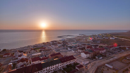 Obraz premium Aktau city on the shore of the Caspian Sea at sunset timelapse. Kazakhstan.