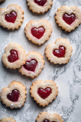Raspberry and Vanilla Heart-Shaped Cookies with Raspberry Jam on Marble Countertop
