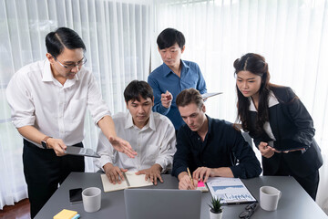 Group of diverse office worker employee working together on strategic business marketing planning in corporate office room. Positive teamwork in business workplace concept. Prudent