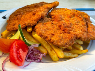 Pork chop with fries.