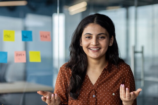 Professional individual expressing confidence and approachability in a modern workplace environment with a friendly and open demeanor, highlighting effective communication and interpersonal skills.