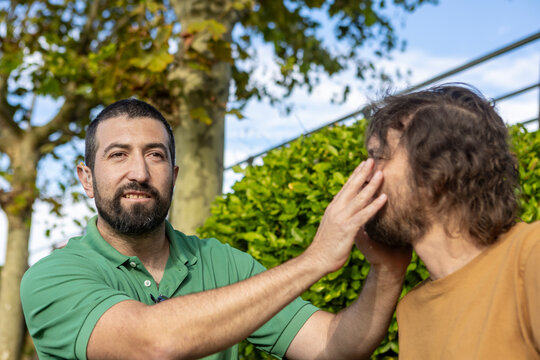 Connection and support between friends in a park setting