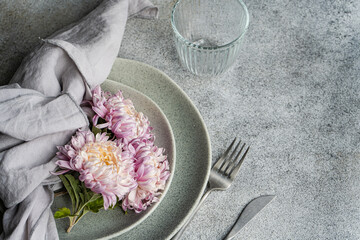 Autumnal chrysanthemum arrangement on rustic dining table setting