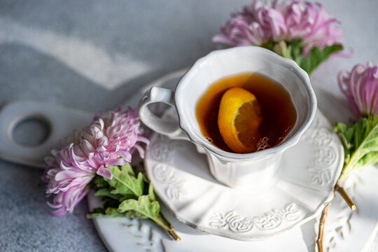 Autumn chrysanthemum tea setup with lemon slice in white cup