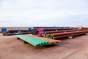 Open warehouse for storing steel pipes of various diameters on the territory of the seaport.