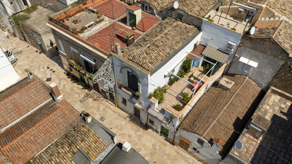 Fototapeta premium Aerial view of an alley in the historic center of the town of Bernalda, in the province of Matera, Basilicata, Italy. It is a traditional Italian village.