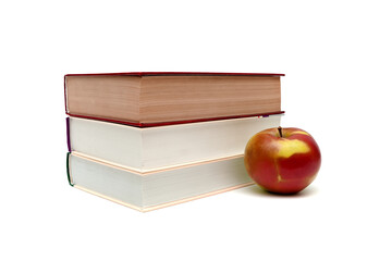 books and ripe apple on a white background
