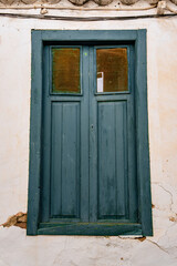 A blue door with a window in the middle