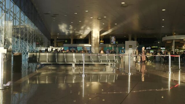 Barcelona 12.10.2024. Airport terminal features a bright, spacious interior with comfortable seating and reflective floors, enhancing elegance, creating a welcoming atmosphere for traveling passengers