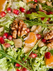 Peking cabbage salad with pomegranate and arugula on a festive table