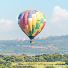 Fototapeta premium A colorful hot air balloon soaring over a scenic landscape.