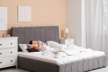 Morning of pretty young woman sleeping in cozy bed