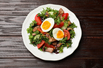 Delicious fresh tuna salad on wooden table, top view