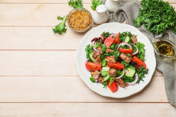 Delicious fresh tuna salad and ingredients on wooden table, flat lay. Space for text
