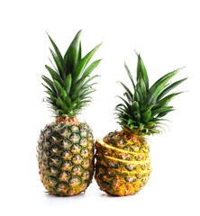 Fototapeta premium Whole and cut ripe pineapples isolated on white