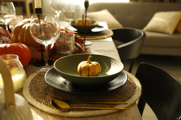 Stylish table setting with beautiful autumn decor in dining room