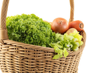 Different fresh vegetables in wicker basket isolated on white