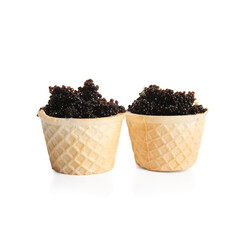 Waffle bowls with delicious black caviar on white background