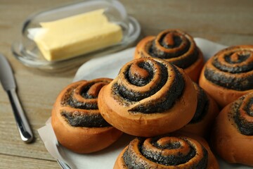 Tasty buns with poppy seeds on table, closeup