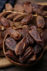 Tasty dried dates on wooden table, closeup