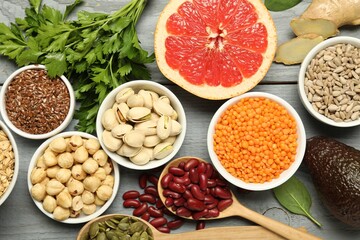 Superfood. Different healthy food products on grey wooden table, flat lay