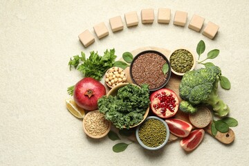 Different superfood products and blank cubes on light table, top view. Space for text