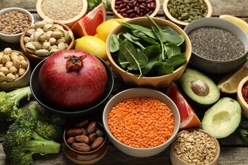 Different superfood products on wooden table, closeup