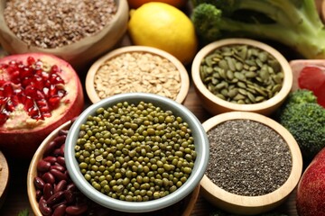 Different superfood products on wooden table, closeup