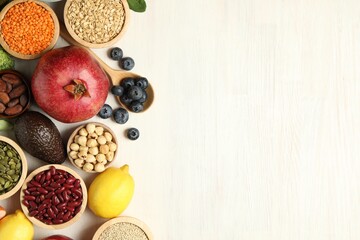Different superfood products on white table, flat lay. Space for text