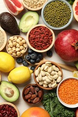 Different superfood products on white table, flat lay