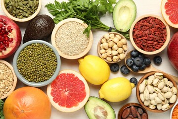 Different superfood products on white table, flat lay