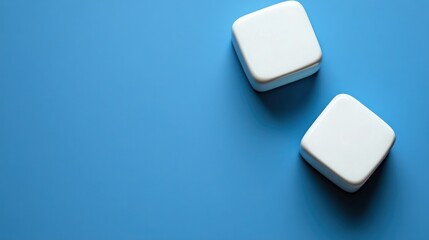 Two white cubes on light blue background.