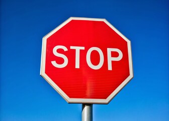 Stop Sign Blue Sky Background, Road Sign Photography, Traffic Sign Image, Stop Sign Graphics,  High-Resolution Stop Sign,  Safety Sign,  Rule of Thirds Composition,  Vibrant Blue Sky,