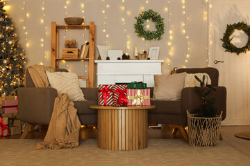 Stylish interior of modern living room with Christmas gifts on wooden table