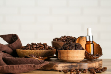 Composition with wooden bowls of coffee body scrub and coffee beans on light background