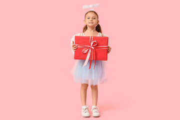 Cute little girl dressed as Cupid with gift box on pink background. Valentine's Day celebration