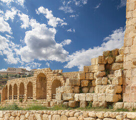 Roman ruins (against the background of a beautiful sky with clouds) in the Jordanian city of Jerash (Gerasa of Antiquity), capital and largest city of Jerash Governorate, Jordan