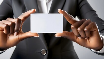 Fototapeta premium Black businesswoman’s hand holding a blank white business card. Business card showing mockup concept