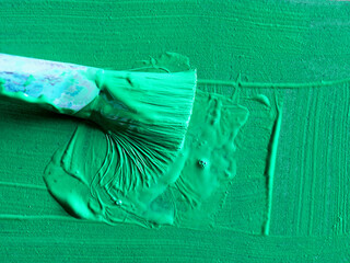 close-up green paintbrush and paint
