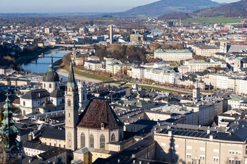 Naklejka premium Aerial cityscape view of Salzburg Austria, on a sunny winter day, as seen from the fortress Hohensalzburg