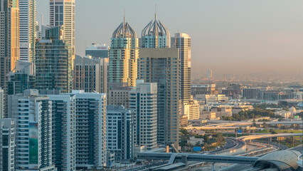 Dubai Marina skyscrapers aerial top view at sunrise from JLT in Dubai timelapse, UAE.